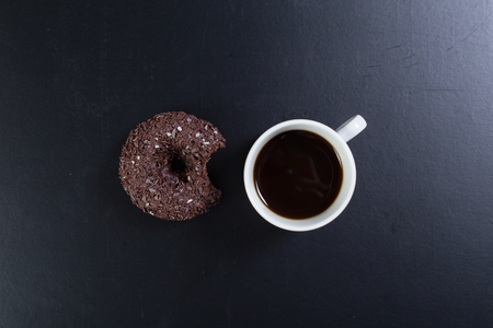 donut and coffee on the black backgroundの写真素材