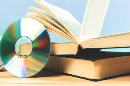 book and DVD disk as symbols of old and new methods of information storageの写真素材