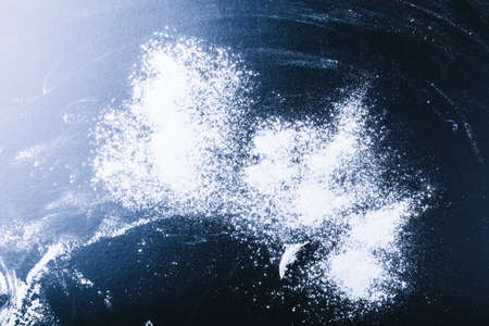 Dark wooden background with flour dustの写真素材