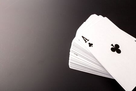 poker chips and cards on black background