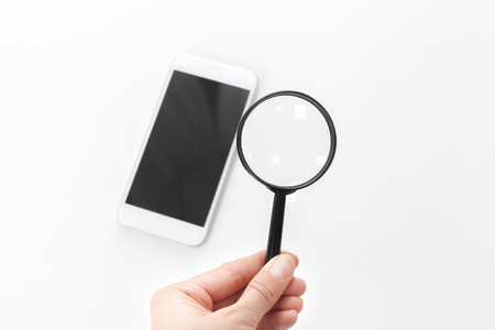 SMARTPHONE WITH MAGNIFYING GLASSの写真素材