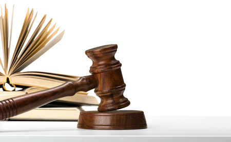Wooden gavel and books on wooden tableの写真素材