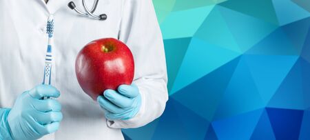 dentist holding a ripe appleの写真素材