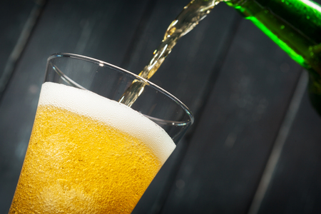 Glass of beer and beer bottleの写真素材