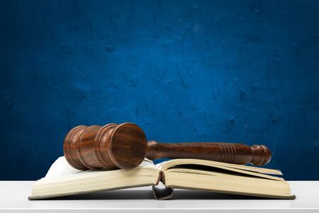 Wooden gavel and books on wooden table