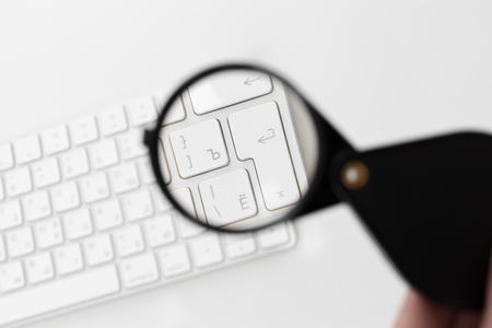 Laptop with a magnifying glassの写真素材