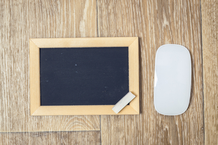 Small blackboard on old wood backgroundの写真素材