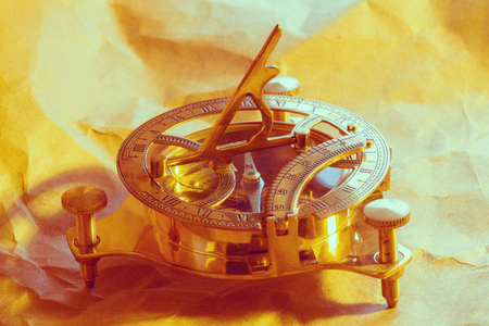 antique compass on vintage paper background