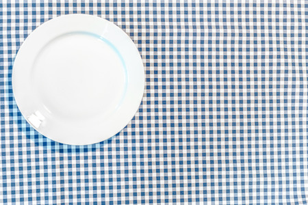 table with blue picnic cloth and plateの写真素材