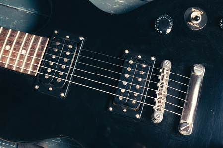 Electric guitar body and neck detail on wooden backgroundの写真素材
