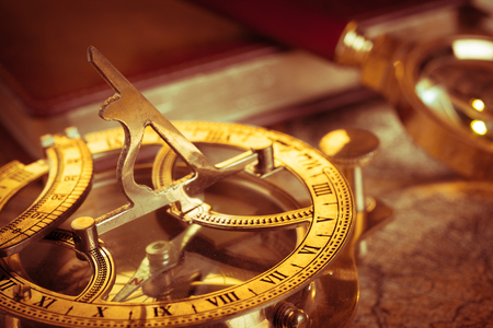 Old vintage compass and travel instruments on ancient mapの写真素材