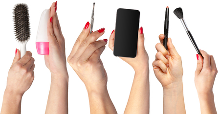 collection of hands holding tools for makeup isolated on whiteの写真素材