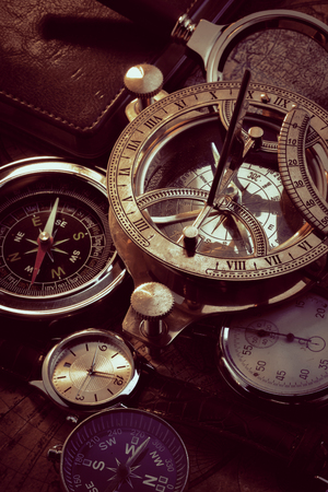 Old vintage compass and travel instruments on ancient mapの写真素材