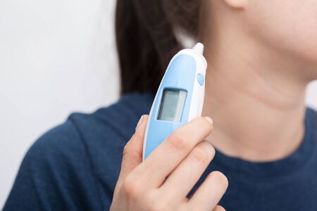 Sick women with a thermometer