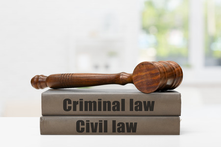 Wooden gavel and books on wooden table
