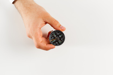 Businessman with a compass holding in hand