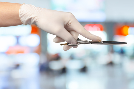 woman's hand holding scissorsの写真素材