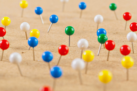 Group of thumbtacks pinned on corkboardの写真素材