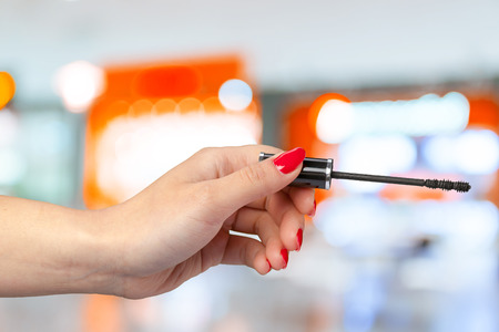 female hand holding a professional makeup brush
