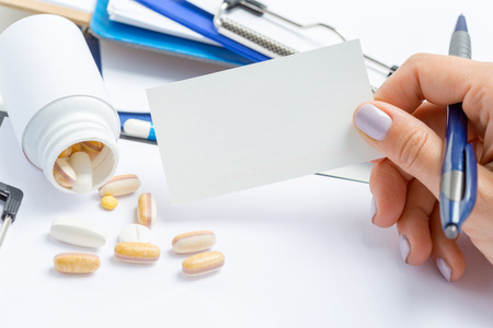 the doctor writes a prescription pilの写真素材
