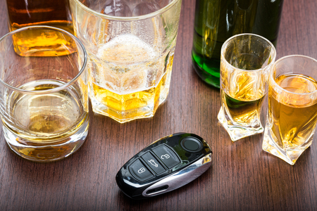 Car key on the bar with spilled alcoholの写真素材
