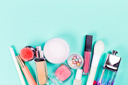 Colorful cosmetics on blue workplace. Top viewの写真素材