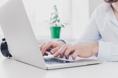 Businessman at work. Close-up top view of man working on laptopの写真素材
