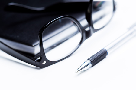 Notebook, pencil and glassesの写真素材