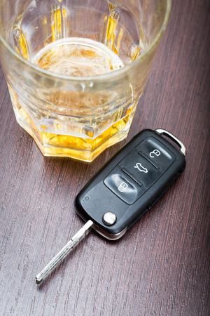 Car key on the bar with spilled alcoholの写真素材