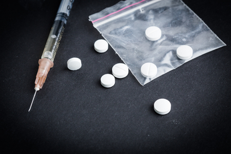 Still life drugs and syringe on tableの写真素材