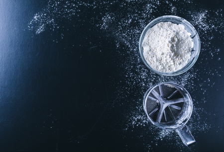 white flour sprinkled on a dark wooden table. top viewの写真素材