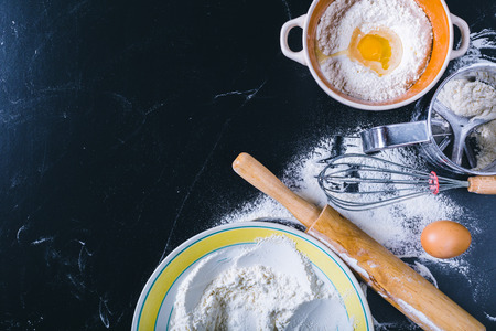 Ingredients and utensil for baking on the black board, top viewの写真素材