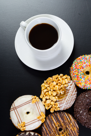 donut and coffee on the black backgroundの写真素材