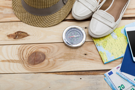 Accessories for travel. Passport, photo camera and travel map. Top view. Holidays and tourism conceptの写真素材