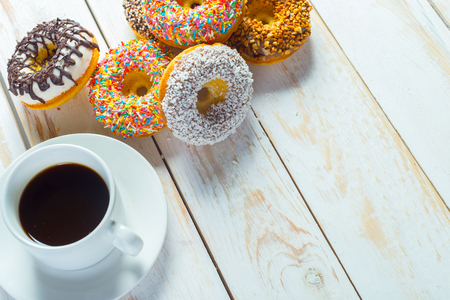 Donuts and coffee on a white wood background.の写真素材