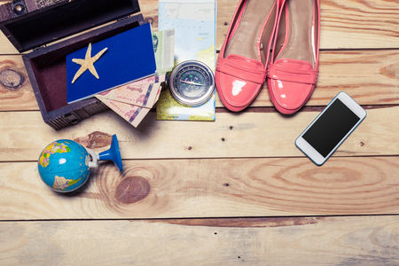 Accessories for travel. Passport, photo camera and travel map. Top view. Holidays and tourism conceptの写真素材