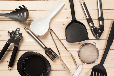 cookware and accessories on a wooden table.の写真素材