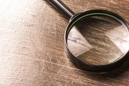 magnifying glass on the  wooden backgroundの写真素材