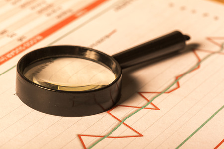 Magnifying glass and business growth graphの写真素材