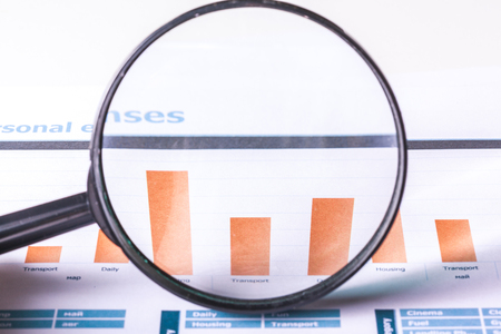 Magnifying glass and business growth graphの写真素材