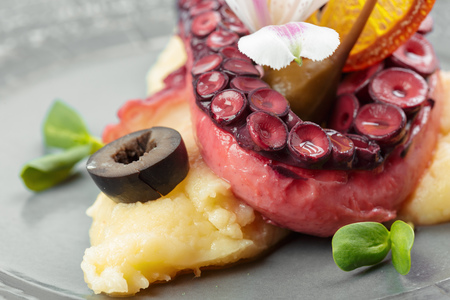 Appetizing octopus with baked potatoesの写真素材