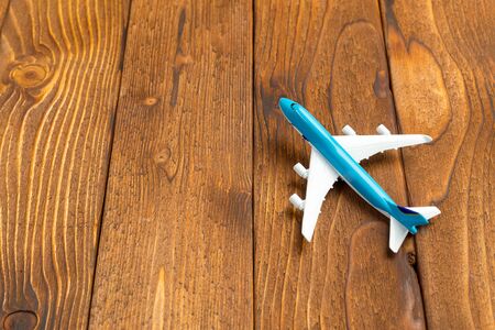 Toy of passenger plane on rustic wooden background