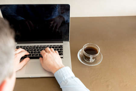 young man in cafe drinking coffee
