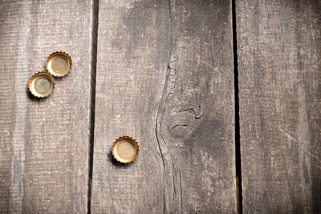 Bottle caps on rustic wooden background