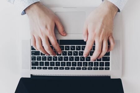 Businessman at work. Close-up top view of man working on laptopの写真素材