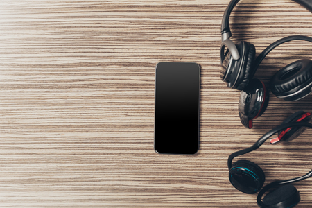 headphones and smart phone on woodの写真素材