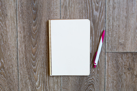 Pen and Notepad on the wooden desk
