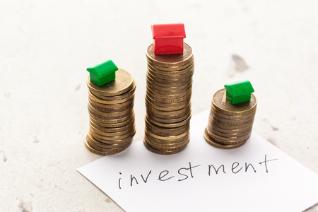 Mortgage concept by model house with coinsの写真素材