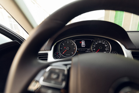 Modern car illuminated dashboard and steering wheel