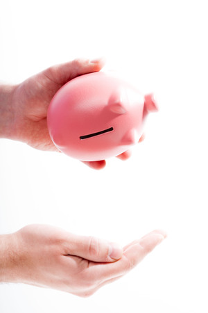 Shaking out empty piggy bankの写真素材